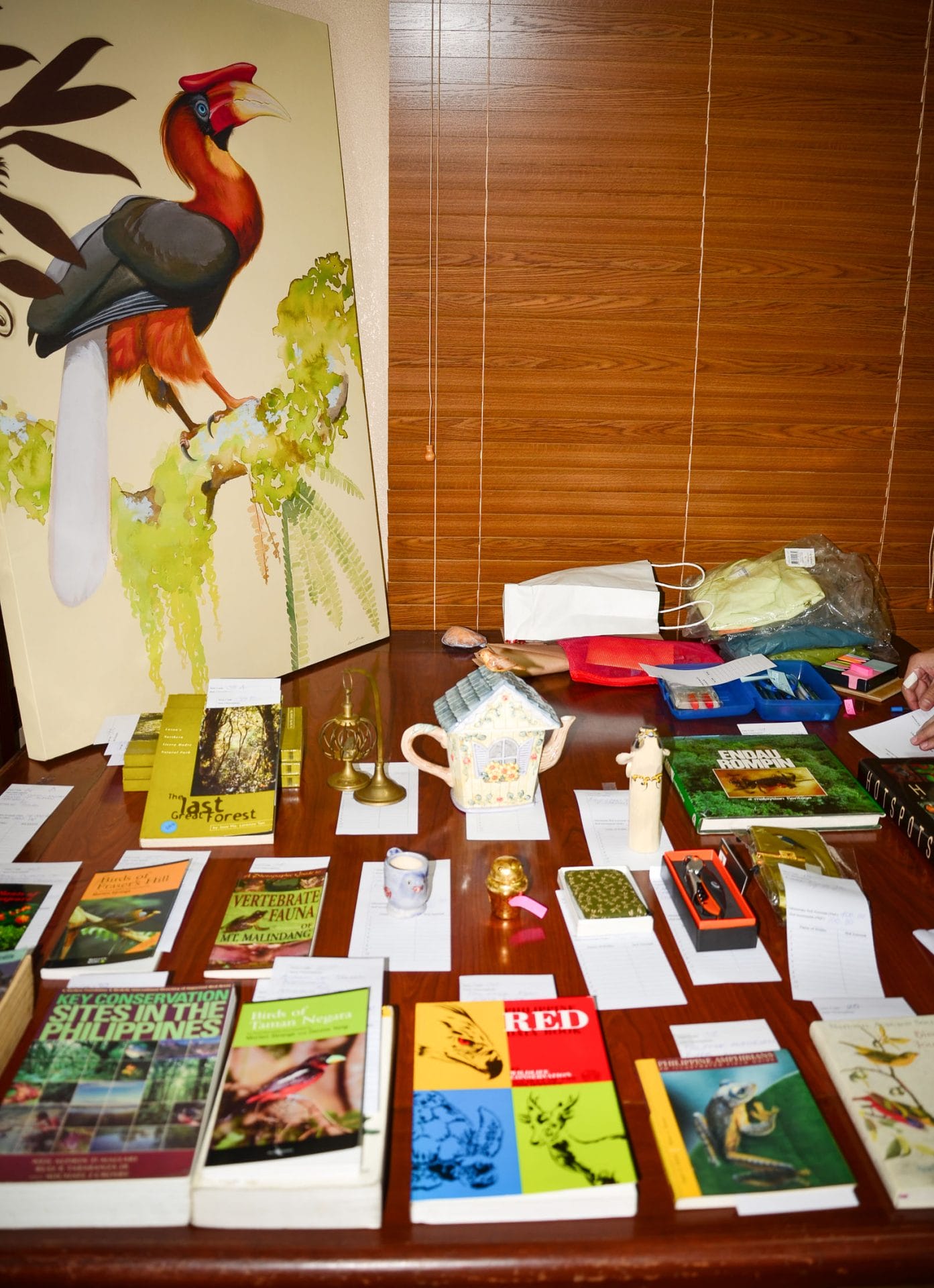 A Hornbill painting, array of books and other items showcased at the Silent Auction area. Photo by Marites Falcon.