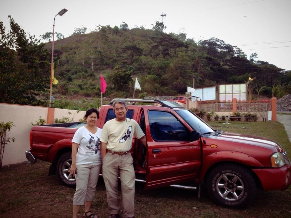 Raptorwatch leads Tere Cervero and Alex Tiongco  in Digos City, Davao del Sur after watching for raptors on the hill in the background. Photo from Tere Cervero.