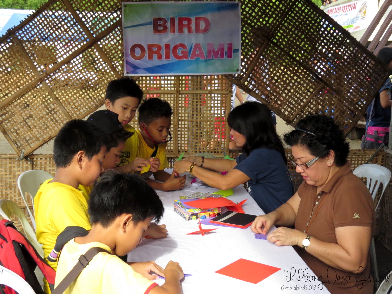 WBCP member Baby Magadia (in brown) assists in the origami booth. Photo by Maia Tanedo